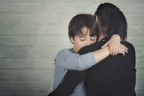 Parent hugging a child