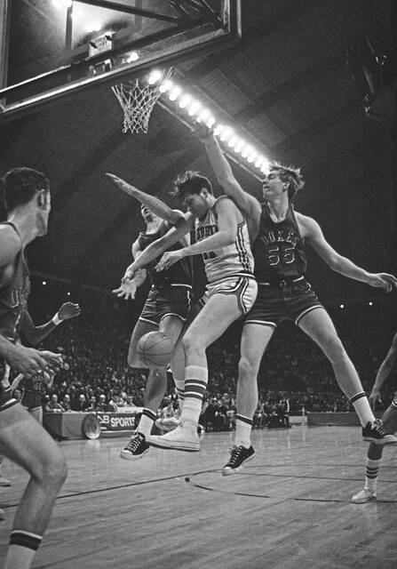 Duquesne’s Garry Nelson (55) and Gary Major (43) bat the ball away from Bill Paultz (11) of St. John’s in first quarter action on March 15, 1969 in the NCAA Eastern Championships consolation game at College Park, Md.