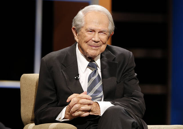Rev. Pat Robertson poses a question to a Republican presidential candidate during a forum at Regent University in Virginia Beach, Va., Oct. 23, 2015.