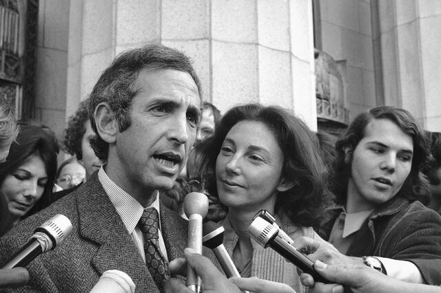 Daniel Ellsberg, a co-defendant in the Pentagon Papers trial, talks to reporters after he testified in Los Angeles, April 12, 1973, as his wife, Patricia Ellsberg, looks on.