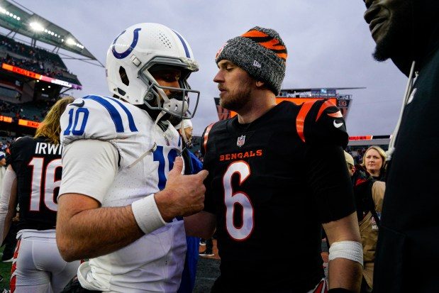 Indianapolis Colts quarterback Gardner Minshew II (10) meets with Cincinnati Bengals quarterback Jake Browning (6) following an NFL football game in Cincinnati, Sunday, Dec. 10, 2023. (AP Photo/Jeff Dean)