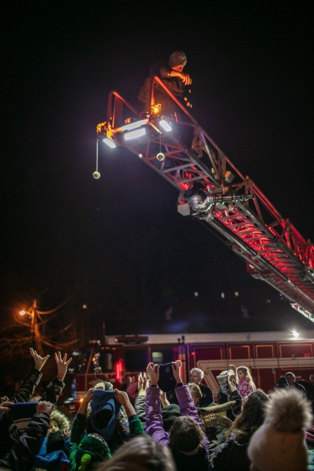 Dec. 7, 2023: Kids reach up to collect coins during the gelt drop with aid from the Mount Airy Volunteer Fire Company.The annual Chanukah Menorah lighting on Main Street in Mt. Airy, co-hosted by the Chabad Jewish Center of Carroll County. (Nate Pesce/ for Carroll County Times)