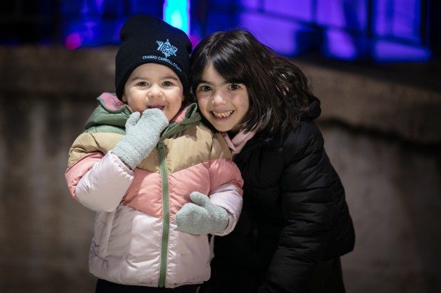 Dec. 7, 2023: Goldie Cohen, 2, of Eldersburg, left, and her sister Shani, 5, pose for a photo at the event.The annual Chanukah Menorah lighting on Main Street in Mt. Airy, co-hosted by the Chabad Jewish Center of Carroll County. (Nate Pesce/ for Carroll County Times)