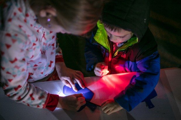 Dec. 7, 2023: Ainsley Campbell, 8, of Mt. Airy, left, and her brother Jack, 4, create custom dreidel designs. The annual Chanukah Menorah lighting on Main Street in Mt. Airy, co-hosted by the Chabad Jewish Center of Carroll County. (Nate Pesce/ for Carroll County Times)