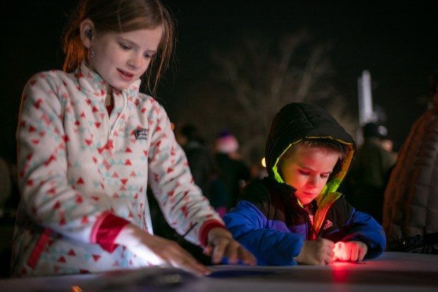 Dec. 7, 2023: Ainsley Campbell, 8, of Mt. Airy, left, and her brother Jack, 4, create custom dreidel designs. The annual Chanukah Menorah lighting on Main Street in Mt. Airy, co-hosted by the Chabad Jewish Center of Carroll County. (Nate Pesce/ for Carroll County Times)