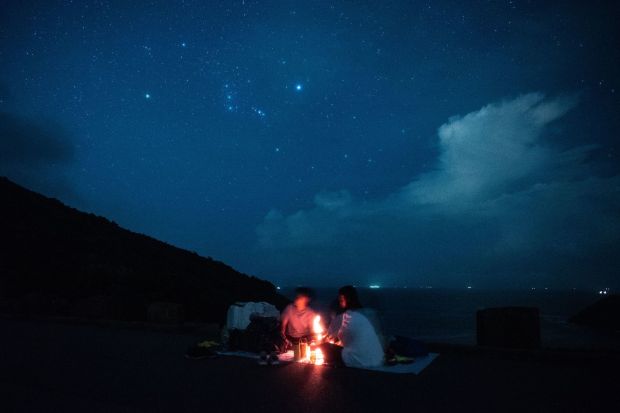 People wait to observe the annual Perseid meteor shower at the east dam of the High Island Reservoir in Hong Kong early on August 13, 2018.