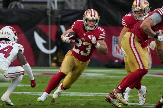 San Francisco 49ers running back Christian McCaffrey (23) throws the ball against the Arizona Cardinals during the first half of an NFL football game, Sunday, Dec. 17, 2023, in Glendale, Ariz. (AP Photo/Rick Scuteri)