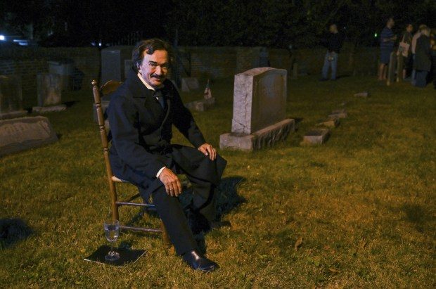 Edgar Allan Poe impersonator David Keltz waits for a tour group at the Reisterstown historic community cemetery.