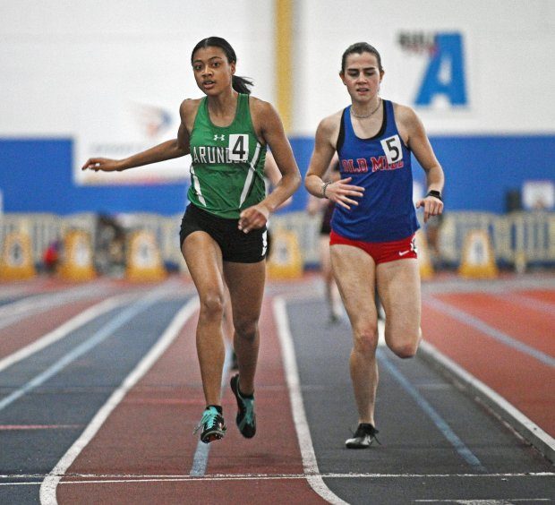 ArundelÕs Noel Evans, left, finishes ahead of Old MillÕs Isabella Shanley, right, in their heat of girls 500 m run in the Class 4A East Region indoor track and field championships at the Prince George's Sports and Learning Complex.Feb. 7, 2023.