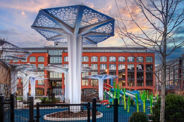 Elijah's Park features a sculptural pavilion structure and a large oval lawn playground with slides, landscaping and a jungle gym shaped like a blue crab.