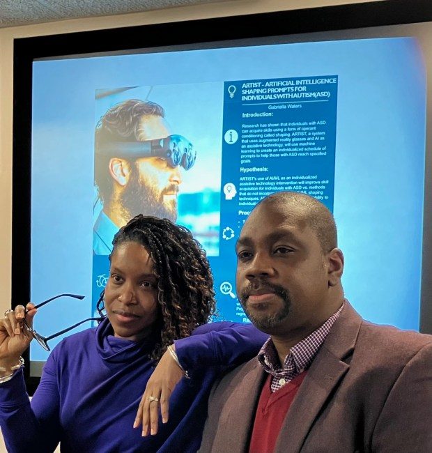 At Morgan State Universityxe2x80x99s Center for Equitable Artificial Intelligence and Machine Learning Systems, Gabriella Waters, director of operations and research, and Kofi Nyarko, director, are in front of a presentation for Watersxe2x80x99 project using augmented reality glasses to help those with autism improve their skills. (Jean Marbella/Staff photo)