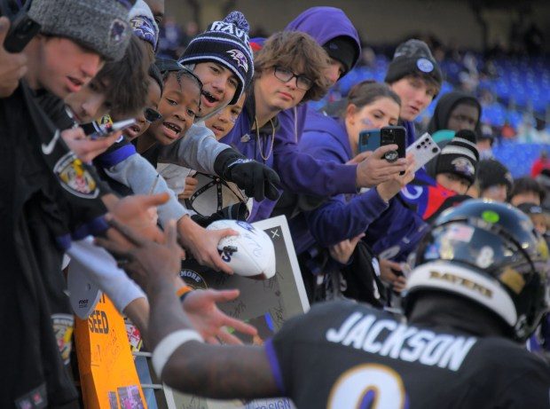 Baltimore Ravens fans shout for quarterback Lamar Jackson who enters to practice during pregame for an AFC matchup of NFL football against the Miami Dolphins in Baltimore Sunday Dec. 31, 2023. (Karl Merton Ferron/Baltimore Sun Staff)