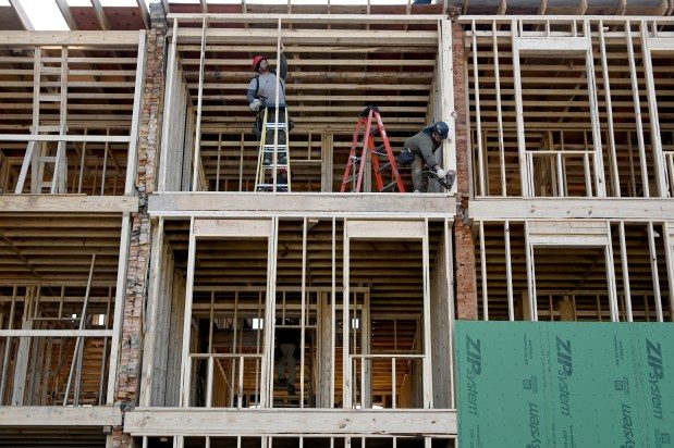 Workers frame rowhomes in the 400 block of East Biddle Street. ReBUILD Metro is reconstructing homes in the 400 and 600 blocks in Johnston Square. (Kim Hairston/Staff photo)