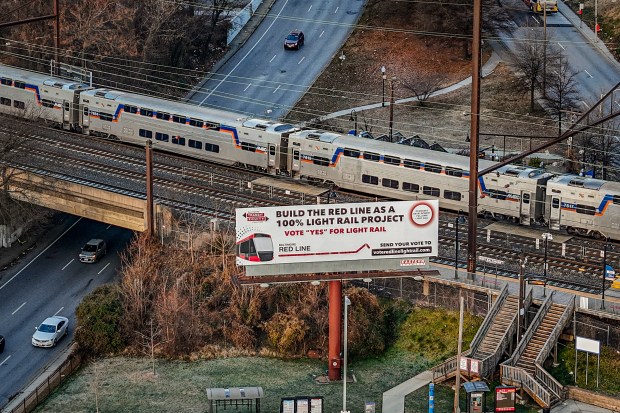 A billboard promoting the Red Line as a Light Rail project is seen at the West Baltimore MARC Station above Franklin Street and Mulberry Street near the end of the 