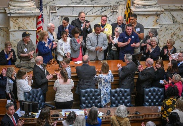 Del. C. T. Wilson, Economic Matters Committee Chair, meets with abuse survivors and advocates in the House Chamber after Gov. Wes Moore signed HB1, the Child Victims Act.